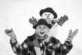 People Love winter. Winter woman. Greeting snowman. Joyful girl Having Fun with snowman in Winter Park. People in snow. Royalty Free Stock Photo