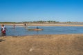 People at low tide cross the river in Morondava harbour.