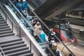 People with luggage on escalator inside main train station Hauptbahnhof in Berlin, Germany