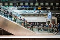 People with luggage on escalator inside main train station Hauptbahnhof in Berlin, Germany