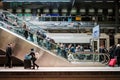 People with luggage on escalator inside main train station Hauptbahnhof in Berlin, Germany