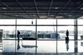 People with luggage waiting hall of airport at window glass Royalty Free Stock Photo