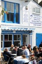 People lunch outside of the fish & chips restaurant