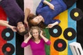 People lying on carpet and listening to music