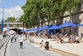 People lying in the sun on the banks of the its in paris