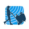 Silhouette of a warehouse worker push a lori chart or hand truck tool transporting sacks. Royalty Free Stock Photo