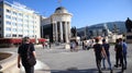 People on main square, modern architecture and historic buildings of Skopje capital city of North Macedonia on sunny summer day