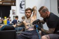 People make a tattoos at the 10-th International Tattoo Convention in the Congress-EXPO Center.