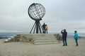 People make travel photo with symbolic globe at North Cape, Norway. Royalty Free Stock Photo