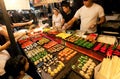 People making choice at Sushi stall with seafood delicacies on the city night market