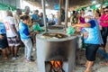 People making food on the wood stove at the Caxixis fair in Nazare, Bahia