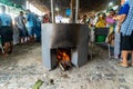 People making food on the wood stove at the Caxixis fair in Nazare, Bahia