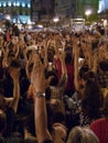 People making silent applause during a rally. 15M