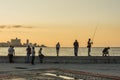 People at Malecon in sunset Havana