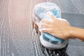 Man is washing dirty cars caused by rain, flooding. Royalty Free Stock Photo