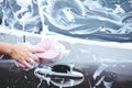 People man holding hand pink sponge for washing car. Concept car wash clean. Royalty Free Stock Photo