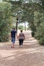 People Man Woman Unidentified Couple Walking Away Nature in Vendee forest near sea coast