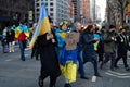 People Marching on a Midtown Manhattan Street in New York City with Ukrainian Flags to Protest the War in Ukraine