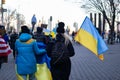 People Marching on a Midtown Manhattan Street in New York City with Ukrainian Flags to Protest the War in Ukraine