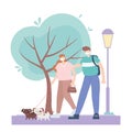 People with medical face mask, couple walking with dogs in the park, city activity during coronavirus Royalty Free Stock Photo