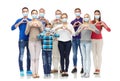 People in medical masks making hand heart gesture