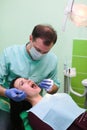 People, medicine, stomatology and health care concept - close up of dentists and assistant with mirror Royalty Free Stock Photo