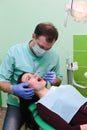 People, medicine, stomatology and health care concept - close up of dentists and assistant with mirror Royalty Free Stock Photo