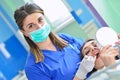 People, medicine, stomatology and health care concept - happy female dentist checking patient girl teeth Royalty Free Stock Photo