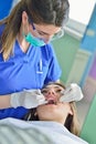 People, medicine, stomatology and health care concept - happy female dentist checking patient girl teeth Royalty Free Stock Photo