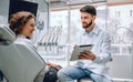 People, medicine, stomatology and health care concept - happy male dentist showing tablet computer to woman patient at dental Royalty Free Stock Photo