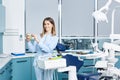 People, medicine, stomatology and healthcare concept - happy young female dentist with tools over medical office Royalty Free Stock Photo