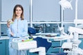 People, medicine, stomatology and healthcare concept - happy young female dentist with tools over medical office Royalty Free Stock Photo