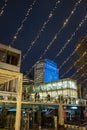 People meeting with friends in Southbank  shell building behind being lit by blue lights. Royalty Free Stock Photo