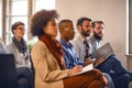 People on meeting listens lecturer