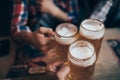 People, men, leisure, friendship and celebration concept - happy male friends drinking beer and clinking glasses at bar or pub Royalty Free Stock Photo