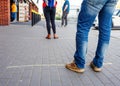 People men and women in a line / queue at the supermarket / mall at a social distance during the quarantine / epidemic