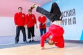 people, men, young people dance a hip-hop sports dance in the Gagarin city park on a summer day. The text in Russian: reads listen