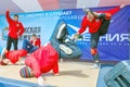 people, men, young people dance a hip-hop sports dance in the Gagarin city park on a summer day. The text in Russian: reads listen