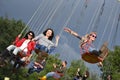 People in merry go round, swing ride, highland spinner