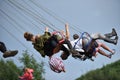 People in merry go round, swing ride, highland spinner