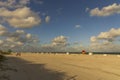 People on Miami Beach relax on sandy beach a beautiful sunny day on the dark blue Atlantic Ocean merging. Royalty Free Stock Photo