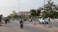 People on mopeds ride on a city street. Typical traffic in an Asian city. City life