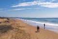 People on Morning Visit to Beach Against Blue Sky