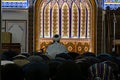People in a Mosque. Muslims kneeling and bowing down while offering prayers during the Muslim festival of Eid. imam Royalty Free Stock Photo
