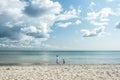 People Mother, daughter walking down the beach at the blue ocean Royalty Free Stock Photo