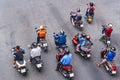 People are on motorbikes in huge Asian city