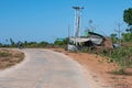 People on motorbikes on a rural asphalt road by a street restaurant, Chaung Thar, Irrawaddy, Myanmar