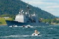 People in motorboats follow norwegian military ship in a fjord in Frogn, Norway.