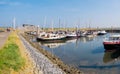 People, motorboats and sailboats in marina of West Frisian island Schiermonnikoog, Netherlands