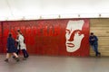 People move past the portrait of the famous poet Mayakovsky, Mayakovskaya metro station